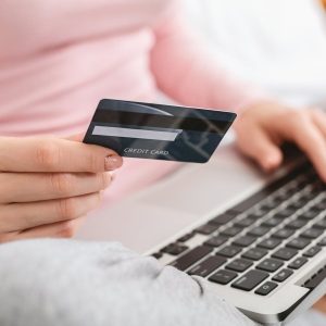 Online banking. Woman checking her bank card balance on laptop, close up